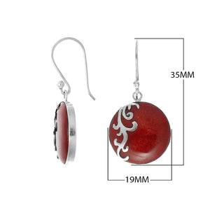 Wholesale sterling silver earrings featuring round red coral drops with a polished wave-motif overlay, crafted to provide consistent artisan quality and elegant catalog-ready presentation for bulk jewelry buyers.