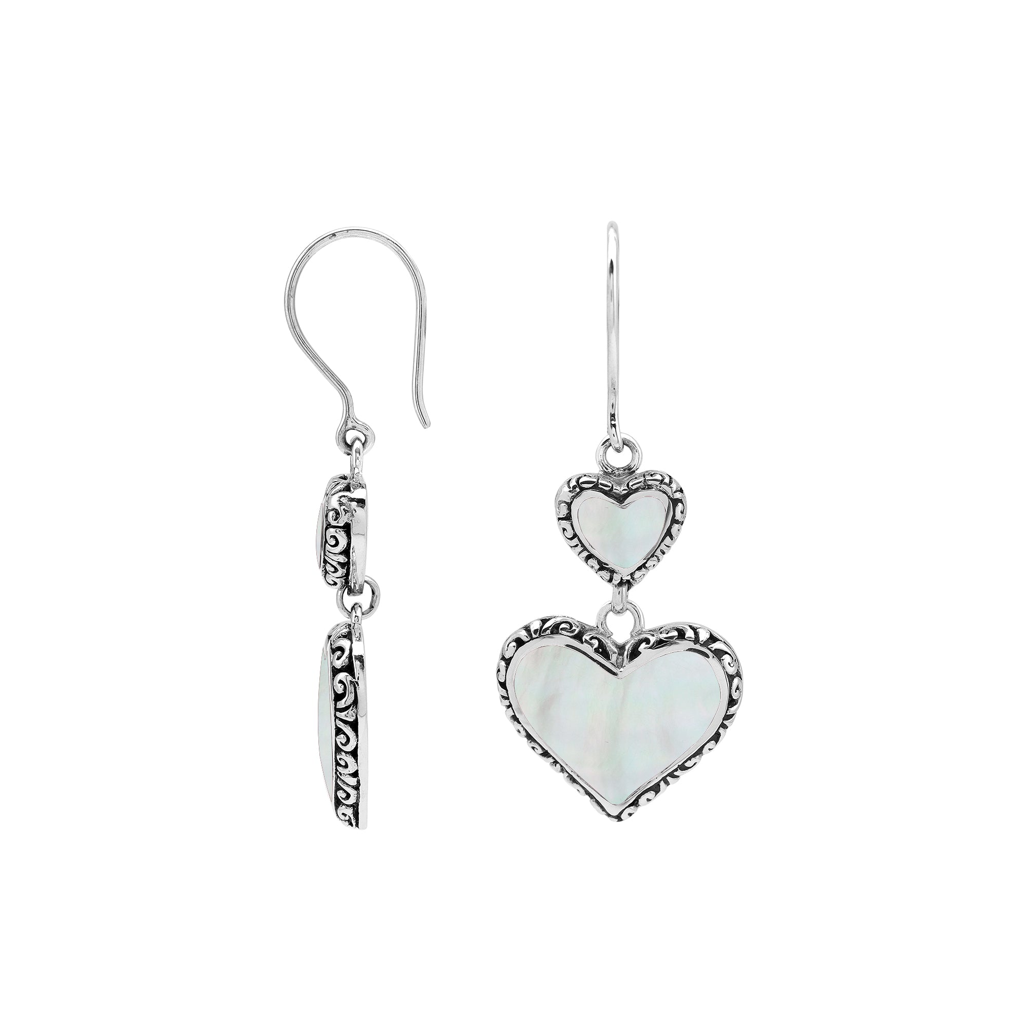 Wholesale sterling silver earrings featuring double mother of pearl heart drops with ornate decorative borders, crafted to deliver consistent artisan quality and elegant catalog-ready presentation for bulk jewelry buyers.