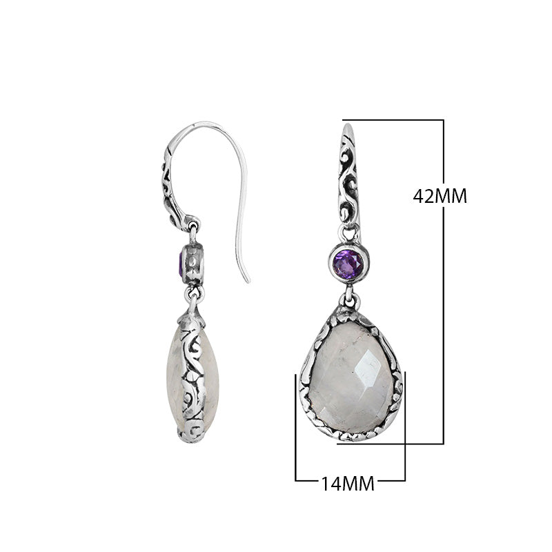 Wholesale sterling silver earrings combining a faceted rainbow moonstone teardrop with an amethyst quartz accent, framed by ornate Balinese detailing for consistent artisan quality and strong catalog-ready wholesale presentation.