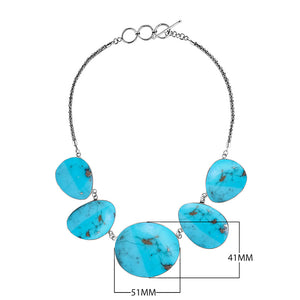 Sterling silver necklace with oval turquoise shell links in polished artisan finish.