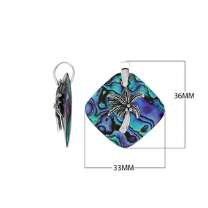 Sterling silver palm tree pendant on abalone shell diamond-shaped base, handmade in Bali for wholesale jewelry buyers.