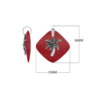 Sterling silver palm tree pendant on coral diamond-shaped base, handmade in Bali for wholesale jewelry buyers.
