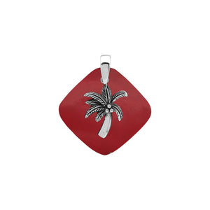 Sterling silver palm tree pendant on coral diamond-shaped base, handmade in Bali for wholesale jewelry buyers.