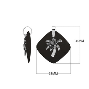 Sterling silver palm tree pendant on black shell diamond-shaped base, handmade in Bali for wholesale jewelry buyers.