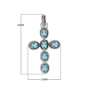 Sterling silver cross pendant with oval faceted blue topaz quartz and beaded detailing, handcrafted in Bali
