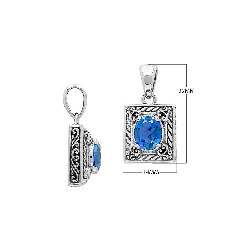 Rectangular sterling silver pendant featuring oval blue topaz quartz, swirl engravings, and smooth mirror-polished finish with detailed Balinese craftsmanship.