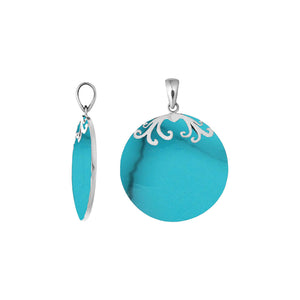 Sterling silver round Turquoise Shell pendant featuring vibrant turquoise blue tones, subtle dark veining, symmetrical floral scrollwork across the upper edge, and a polished tapered silver bail, shown from front and side views.