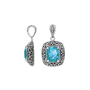 Sterling silver cushion pendant featuring a faceted Blue Topaz Quartz centerpiece accented with intricate Balinese scroll carvings and a polished decorative frame.