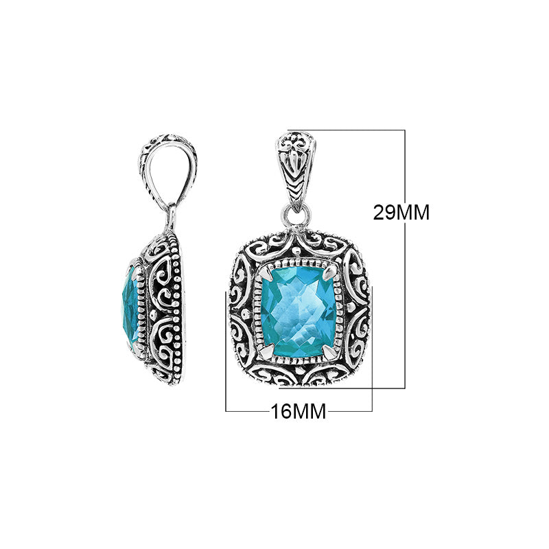 Sterling silver cushion pendant featuring a faceted Blue Topaz Quartz centerpiece accented with intricate Balinese scroll carvings and a polished decorative frame.