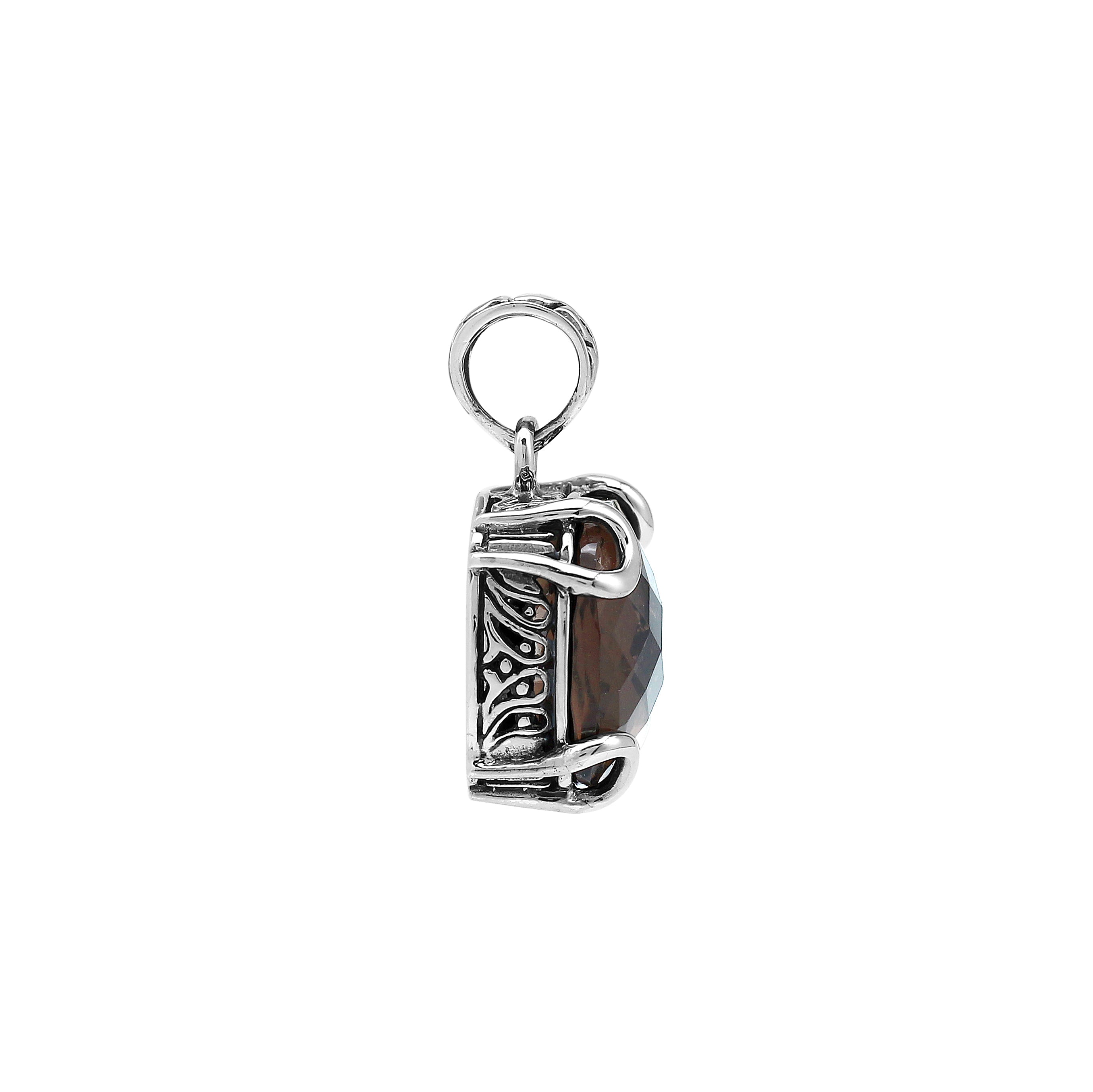 Sterling silver cushion pendant featuring a faceted Smokey Quartz centerpiece secured with decorative prong detailing and traditional Balinese carved ornamentation.