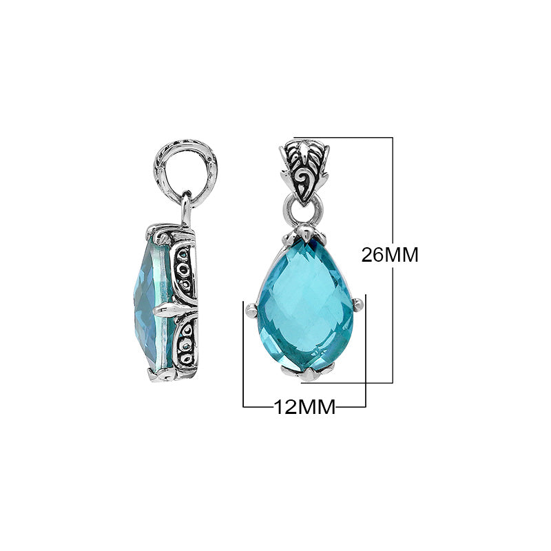 Sterling silver pear-shaped pendant featuring a faceted Blue Topaz Quartz centerpiece with polished prong-setting and intricate Balinese carved detailing.