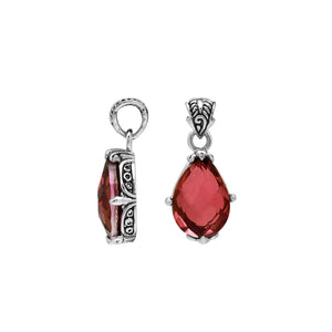 Sterling silver pear-shaped pendant featuring a faceted Red Garnet Quartz center with polished prong-setting and intricate Balinese carved ornamental accents.