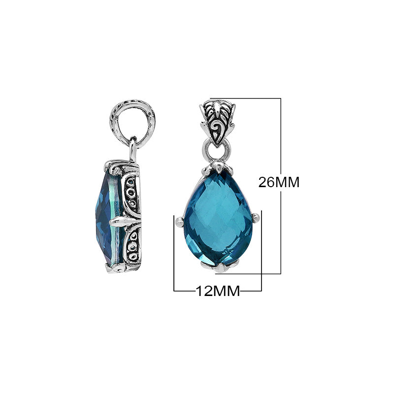 Sterling silver pear-shaped pendant featuring a faceted London Blue Topaz Quartz center with polished prong-setting and traditional Balinese carved ornamental detailing.