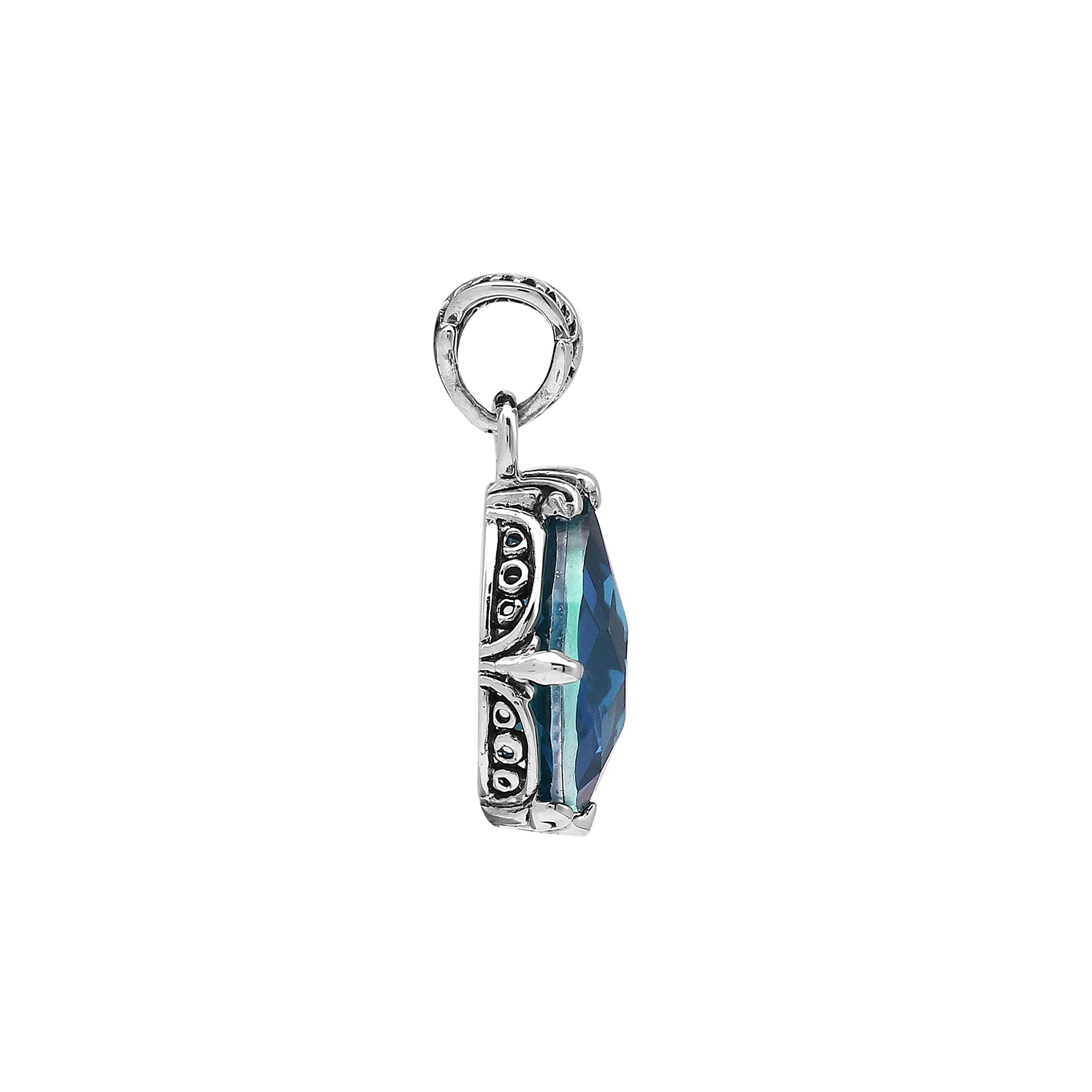 Sterling silver pear-shaped pendant featuring a faceted London Blue Topaz Quartz center with polished prong-setting and traditional Balinese carved ornamental detailing.