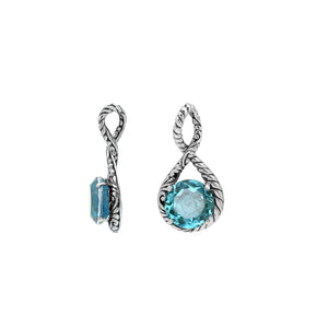 Sterling silver twisted loop pendant featuring a faceted Blue Topaz Quartz center with detailed Balinese engraving and polished round artistic setting.