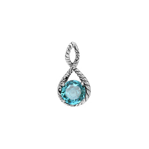 Sterling silver twisted loop pendant featuring a faceted Blue Topaz Quartz center with detailed Balinese engraving and polished round artistic setting.
