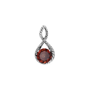 Sterling silver twisted loop pendant featuring a round faceted Red Garnet Quartz centerpiece with carved Balinese detailing and polished artistic round setting.