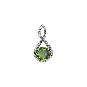 Sterling silver twisted loop pendant featuring a round Peridot Quartz centerpiece with carved Balinese engraving and polished artistic round design.