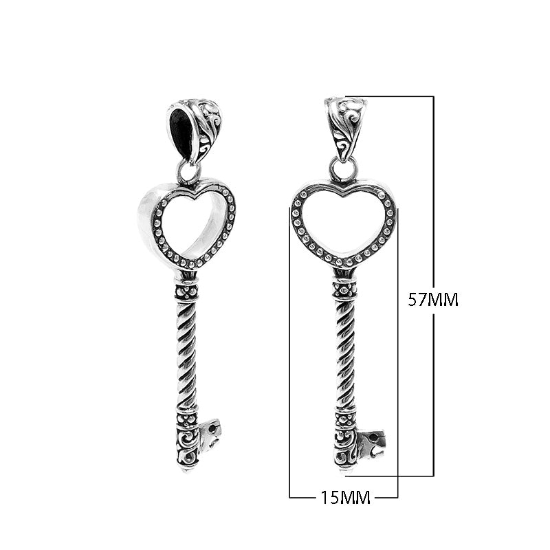 Sterling silver heart-shaped key pendant featuring dotted texturing, twisted stem detailing, and polished finishing suitable for classic wholesale jewelry displays