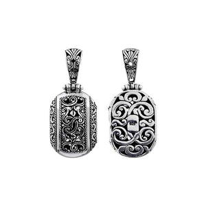 A wholesale Silver Overlay Over Copper oval pendant featuring ornate Balinese scrollwork, oxidized detailing, polished highlights, and a refined silver overlay design ideal for bulk jewelry buyers.