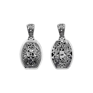 A wholesale Silver Overlay Over Copper oval pendant featuring detailed Balinese scrollwork, oxidized antique textures, polished overlay accents, and traditional filigree artistry ideal for bulk jewelry buyers.
