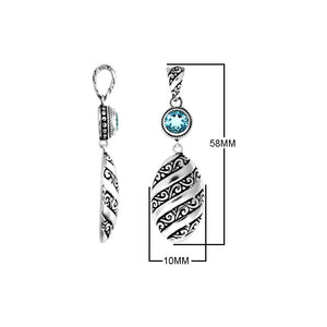 A wholesale Silver Overlay Over Copper pendant featuring a sparkling blue topaz quartz stone, detailed Balinese spiral patterns, oxidized textures, and polished highlights ideal for bulk jewelry purchasing.
