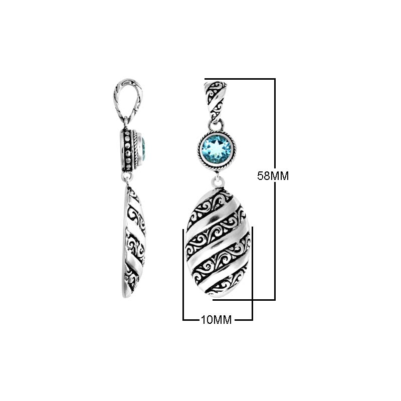 A wholesale Silver Overlay Over Copper pendant featuring a sparkling blue topaz quartz stone, detailed Balinese spiral patterns, oxidized textures, and polished highlights ideal for bulk jewelry purchasing.