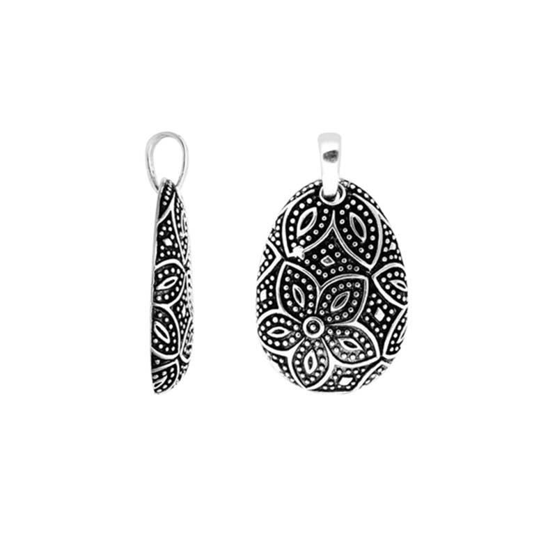 A wholesale Silver Overlay Over Copper pendant featuring oxidized floral etching, dotted detailing, polished overlay texture, and traditional Balinese artistry ideal for bulk jewelry purchasing.