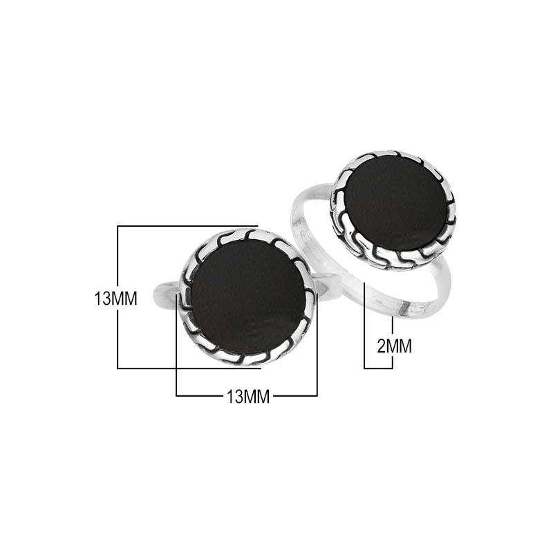 Sterling silver round Black Shell statement ring featuring a smooth dark centerpiece, sculpted decorative border, oxidized detailing, and polished silver band.