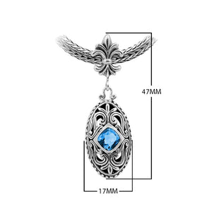 Sterling Silver Ornate Oval Pendant Featuring Blue Topaz Quartz With Fleur-De-Lis Decorative Bail.