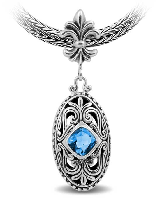 Sterling Silver Ornate Oval Pendant Featuring Blue Topaz Quartz With Fleur-De-Lis Decorative Bail.