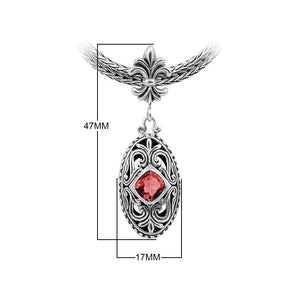 Sterling Silver Ornate Oval Pendant Featuring Garnet Quartz With Fleur-De-Lis Decorative Bail.
