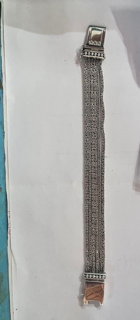 Sterling silver multi-chain panel bracelet with polished finish and handcrafted silver detailing.