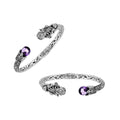 A wholesale sterling silver octopus-inspired bangle featuring a vivid amethyst quartz stone, intricate Balinese carvings, oxidized detailing, and a secure hinge lock mechanism ideal for bulk jewelry buying.