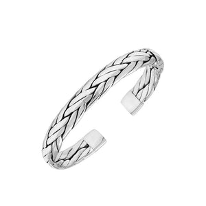 A wholesale sterling silver large woven bangle featuring bold Balinese textures, polished detailing, and a secure hinge lock, ideal for premium bulk jewelry purchasing.