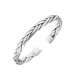 A wholesale sterling silver small woven bangle featuring polished Balinese textures, smooth finishing, and a secure hinge lock perfect for lightweight premium jewelry collections.