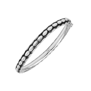 Sterling silver medium-size bangle featuring bold oval textured detailing, polished and oxidized finish, and secure hinge lock with safety latch for wholesale jewelry buyers.