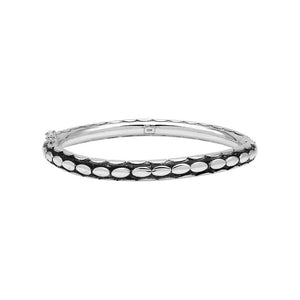 Sterling silver medium-size bangle featuring bold oval textured detailing, polished and oxidized finish, and secure hinge lock with safety latch for wholesale jewelry buyers.