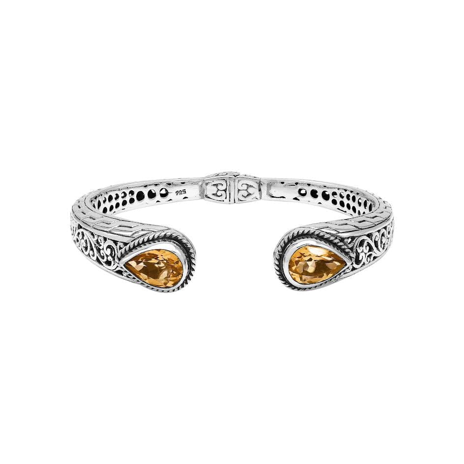Sterling silver bangle featuring teardrop citrine quartz stones, ornate Bali engraving, oxidized accents, and a secure hinge lock made for premium wholesale jewelry collections.