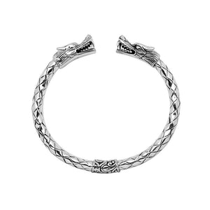 Wholesale sterling silver dragon head cuff bangle featuring detailed carvings, textured patterning, and a secure hinge-lock mechanism designed for reliable and consistent bulk inventory.