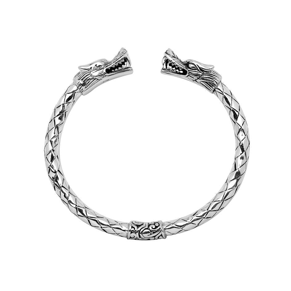 Wholesale sterling silver dragon head cuff bangle featuring detailed carvings, textured patterning, and a secure hinge-lock mechanism designed for reliable and consistent bulk inventory.