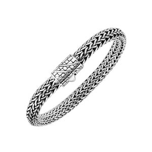 A wholesale sterling silver wide woven bracelet featuring an engraved push clasp, polished and oxidized detailing, and bold textured links crafted for premium bulk jewelry collections.