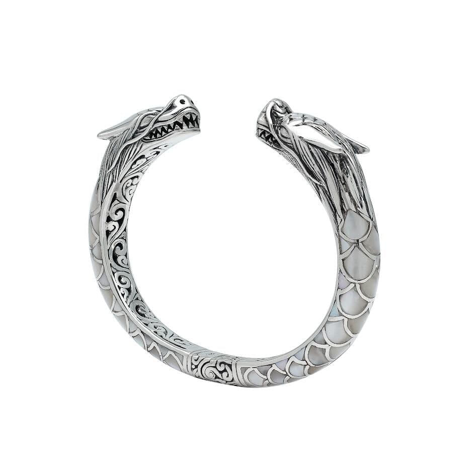 Wholesale sterling silver phoenix bangle featuring Mother of Pearl accents, detailed Balinese scroll carving, and a secure hinge lock ideal for premium artisan jewelry collections.