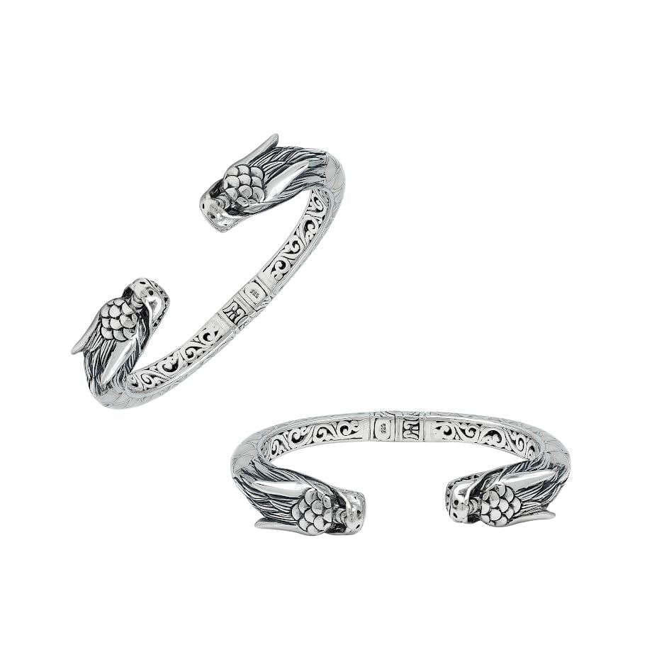 Wholesale sterling silver phoenix bangle featuring Mother of Pearl accents, detailed Balinese scroll carving, and a secure hinge lock ideal for premium artisan jewelry collections.