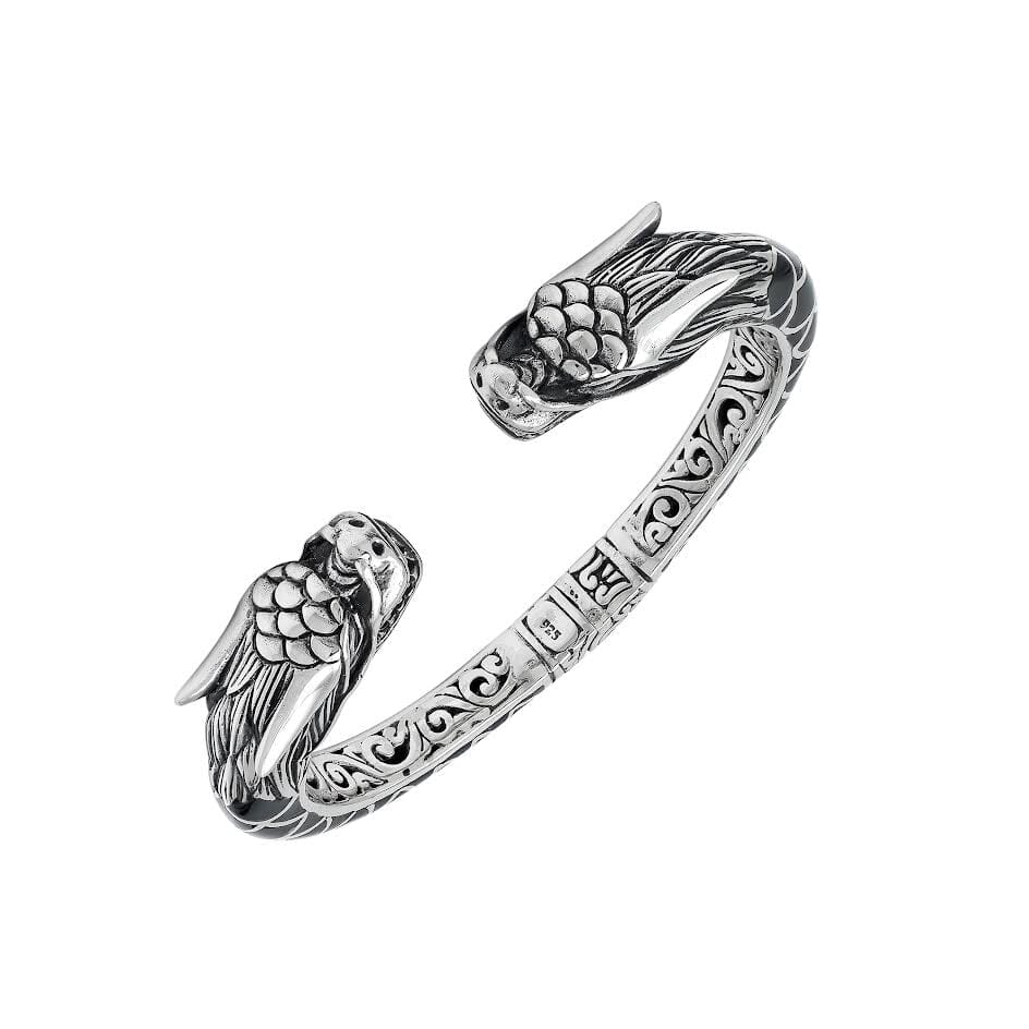 Wholesale sterling silver phoenix bangle featuring Black Shell insets, ornate Balinese scroll carving, and a sturdy hinge lock, crafted for premium artisan wholesale jewelry assortments.