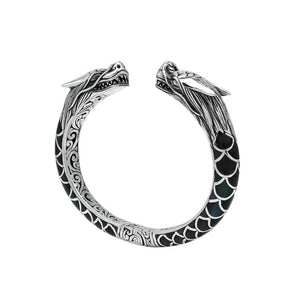 Wholesale sterling silver phoenix bangle featuring Black Shell insets, ornate Balinese scroll carving, and a sturdy hinge lock, crafted for premium artisan wholesale jewelry assortments.