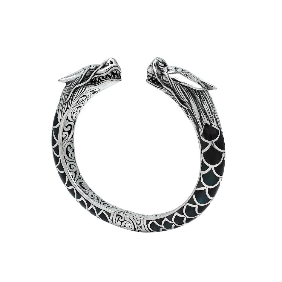 Wholesale sterling silver phoenix bangle featuring Black Shell insets, ornate Balinese scroll carving, and a sturdy hinge lock, crafted for premium artisan wholesale jewelry assortments.