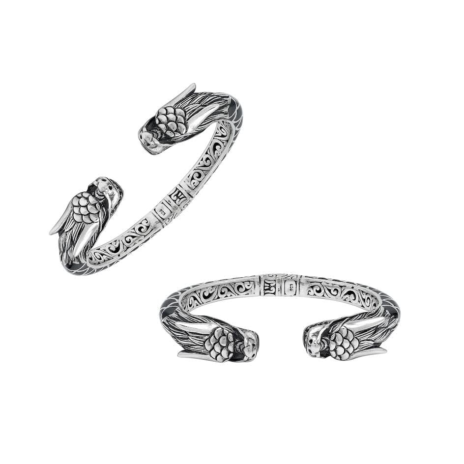 Wholesale sterling silver phoenix bangle featuring Black Shell insets, ornate Balinese scroll carving, and a sturdy hinge lock, crafted for premium artisan wholesale jewelry assortments.