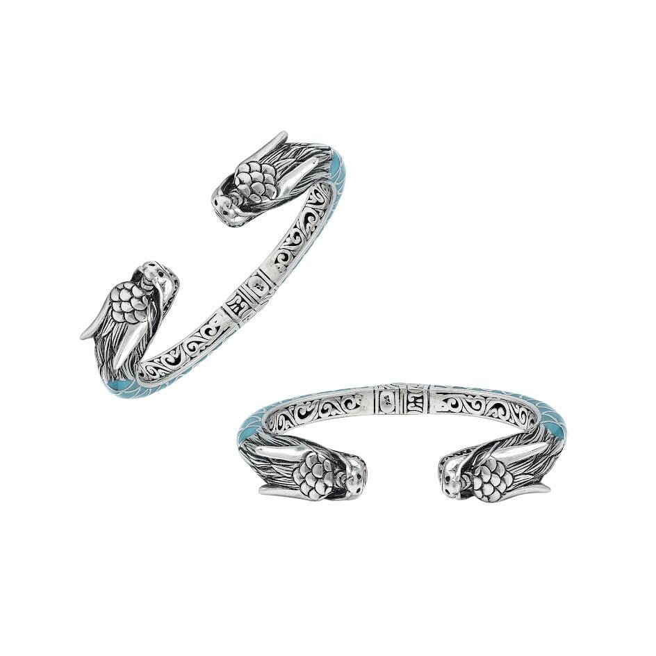 Wholesale sterling silver phoenix bangle featuring Turquoise Shell accents, ornate Balinese scroll engravings, and a secure hinge lock crafted for premium artisan wholesale jewelry collections.
