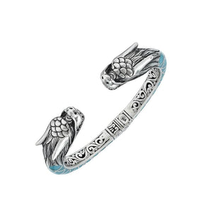Wholesale sterling silver phoenix bangle featuring Turquoise Shell accents, ornate Balinese scroll engravings, and a secure hinge lock crafted for premium artisan wholesale jewelry collections.